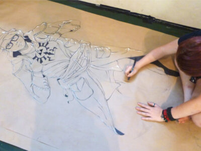 Künstlerin zeichnet Anime-Figur auf Papier. Illustration, Kunst, Zeichnung.